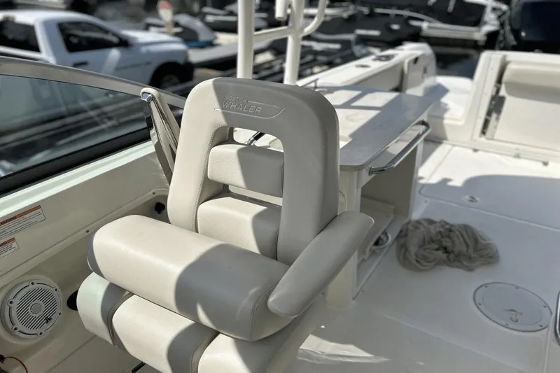 Slide: The Image of 2017 Boston Whaler 270 Vantage boat interior with cushioned seating and storage area. - 20