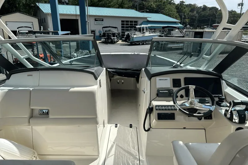 Slide: The Image of 2017 Boston Whaler 270 Vantage boat interior with steering wheel and control panel. - 25
