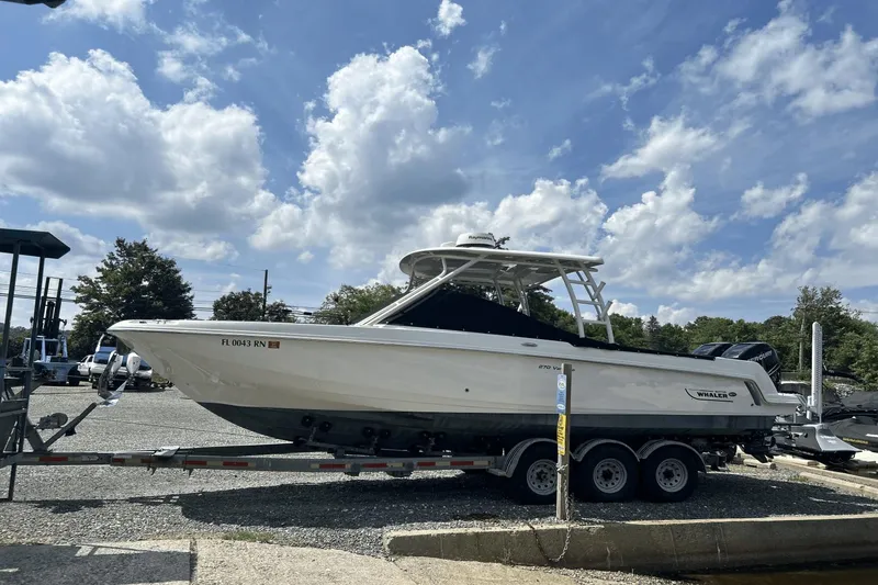 Slide: The Image of 2017 Boston Whaler 270 Vantage boat on trailer under a partly cloudy sky. - 3