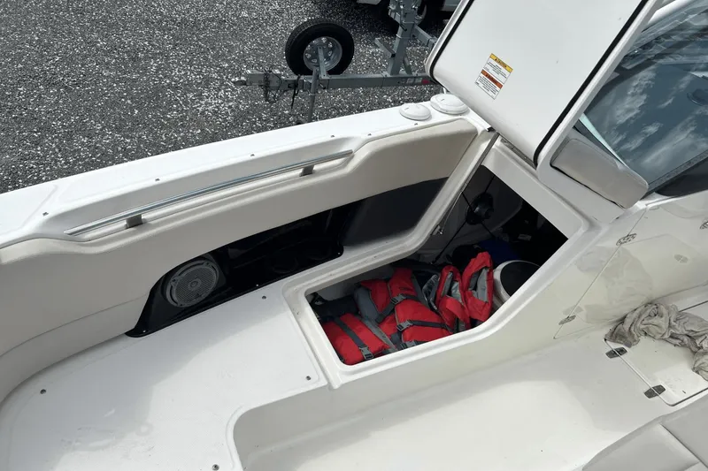 Slide: The Image of 2017 Boston Whaler 270 Vantage boat storage compartment with life jackets and speaker. - 30