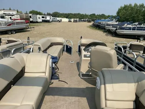 Slide: The Image of 2019 Sun Tracker Party Barge 22 XP3 pontoon boat with beige seating in a storage lot. - 8