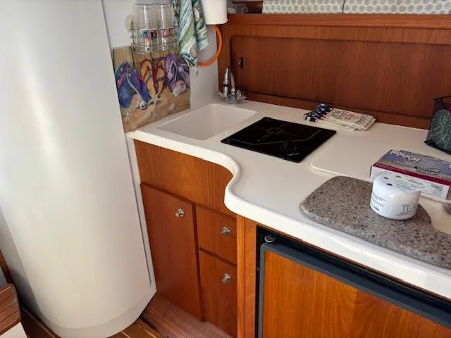 Slide: The Image of Interior of 2001 Tiara Yachts 2900 Open with cozy seating and dining area. - 21