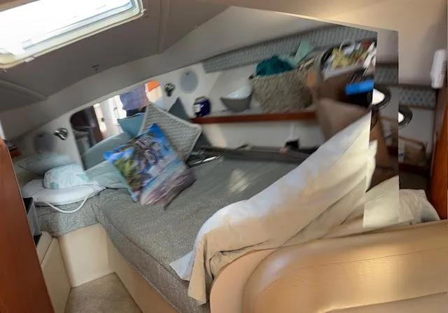 Slide: The Image of Interior dining area of 2001 Tiara Yachts 2900 Open with wooden table and cushioned seating. - 24