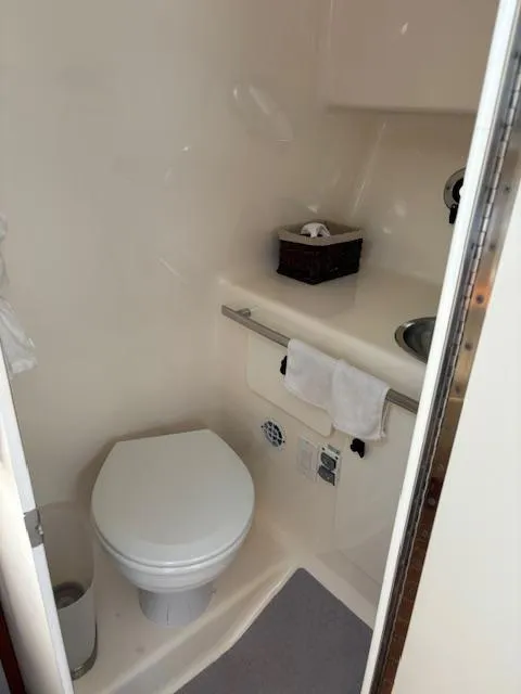 Slide: The Image of Compact bathroom in 2001 Tiara Yachts 2900 Open, featuring a toilet and sink. - 29