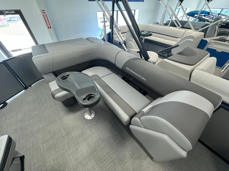 Slide: The Image of 2024 Bennington 20SL pontoon boat interior with gray seating and cup holders. - 3