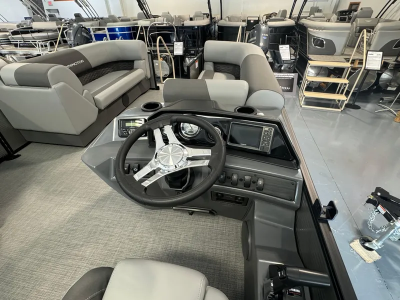 Slide: The Image of 2024 Bennington 20SL boat interior with steering wheel and seating area. - 4