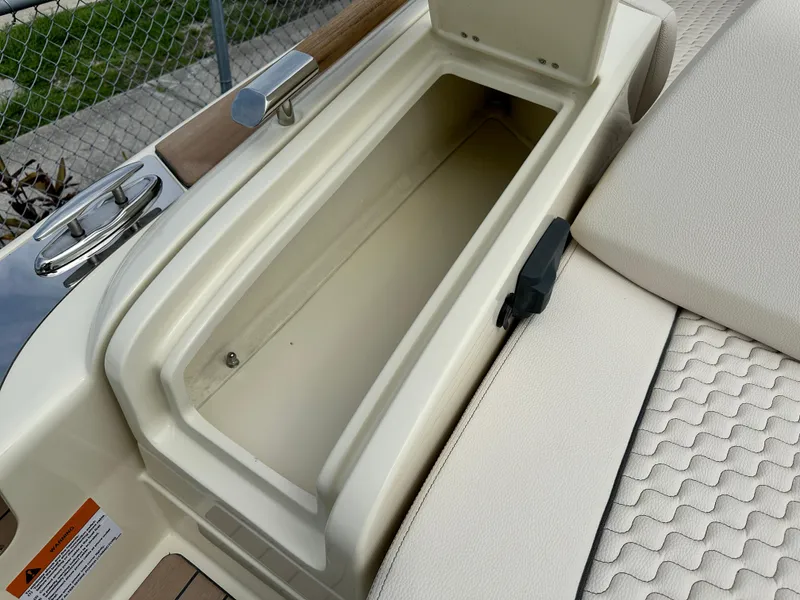 Slide: The Image of 2025 Chris-Craft Launch 31 GT storage compartment with open lid. - 10
