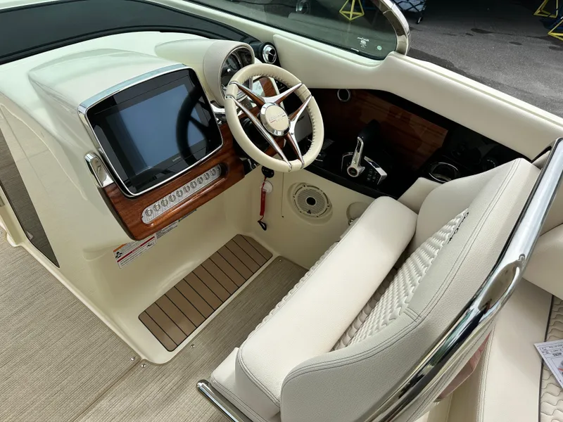 Slide: The Image of 2025 Chris-Craft Launch 31 GT boat cockpit with modern steering wheel and touchscreen display. - 19