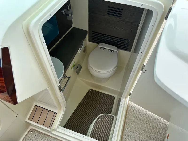 Slide: The Image of 2025 Chris-Craft Launch 31 GT boat interior bathroom with toilet and sink. - 31