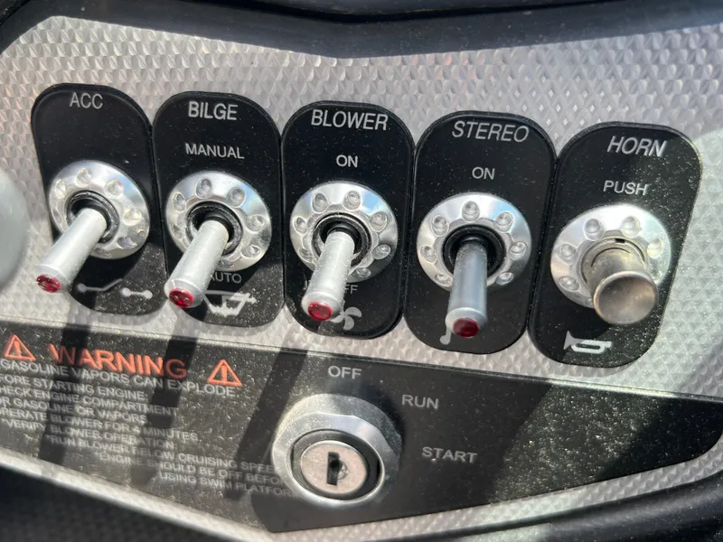 Slide: The Image of Control panel of a 2015 Supra SG 400 boat with switches and ignition. - 27