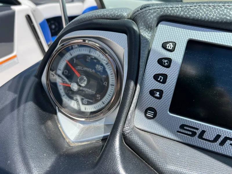 Slide: The Image of Dashboard of a 2015 Supra SG 400 boat with gauge and control panel. - 30