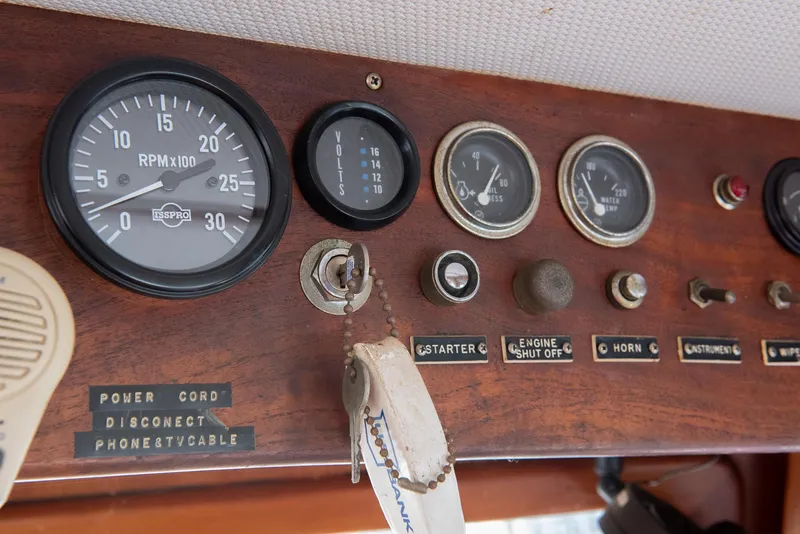 Slide: The Image of 1978 CHB Puget Trawler 37 dashboard with gauges, ignition, and control switches. - 12