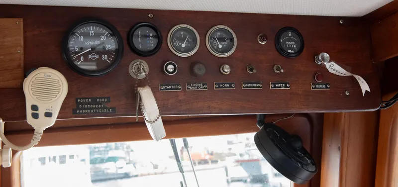 Slide: The Image of 1978 CHB Puget Trawler 37 dashboard with gauges and controls. - 13