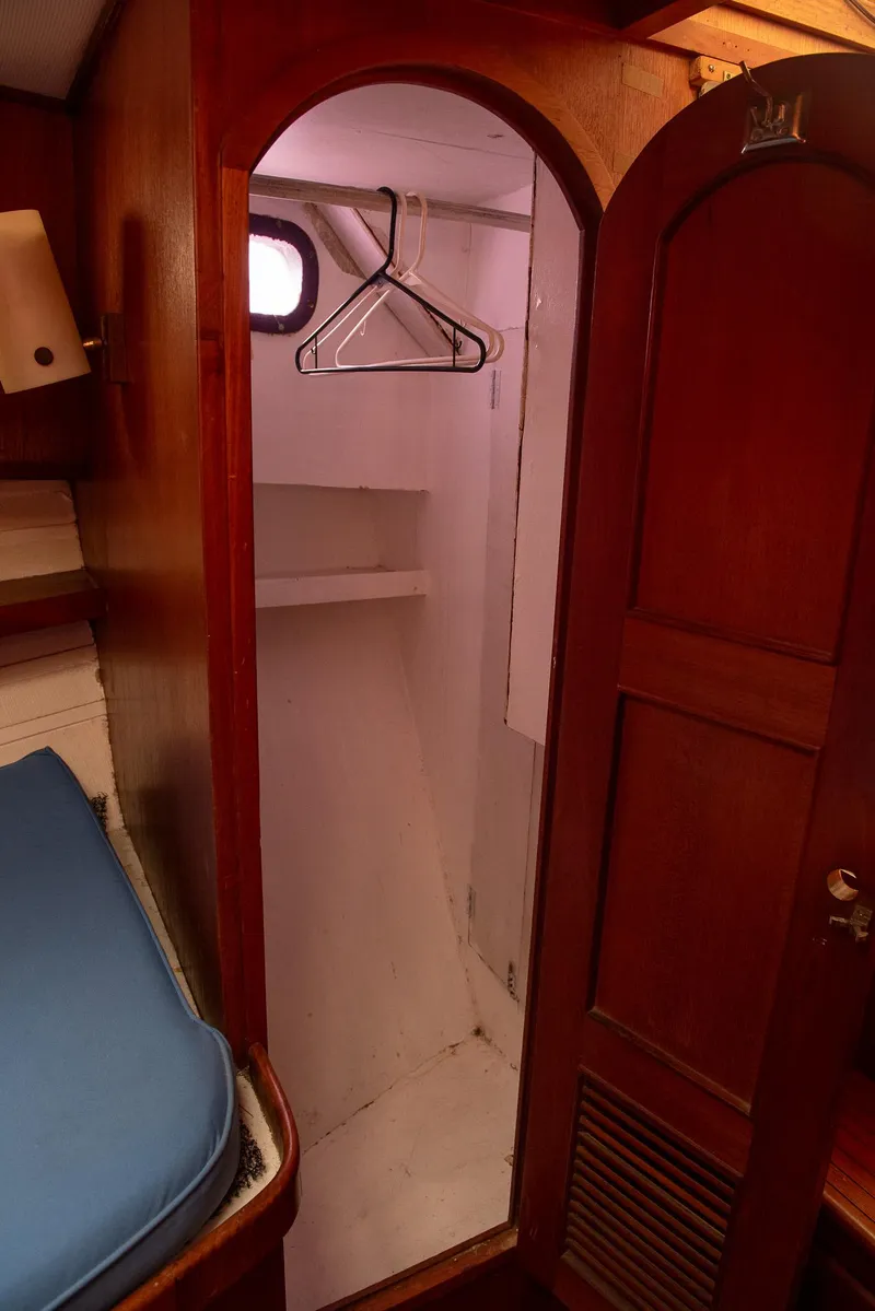 Slide: The Image of 1978 CHB Puget Trawler 37 interior closet with wooden door and hangers. - 19