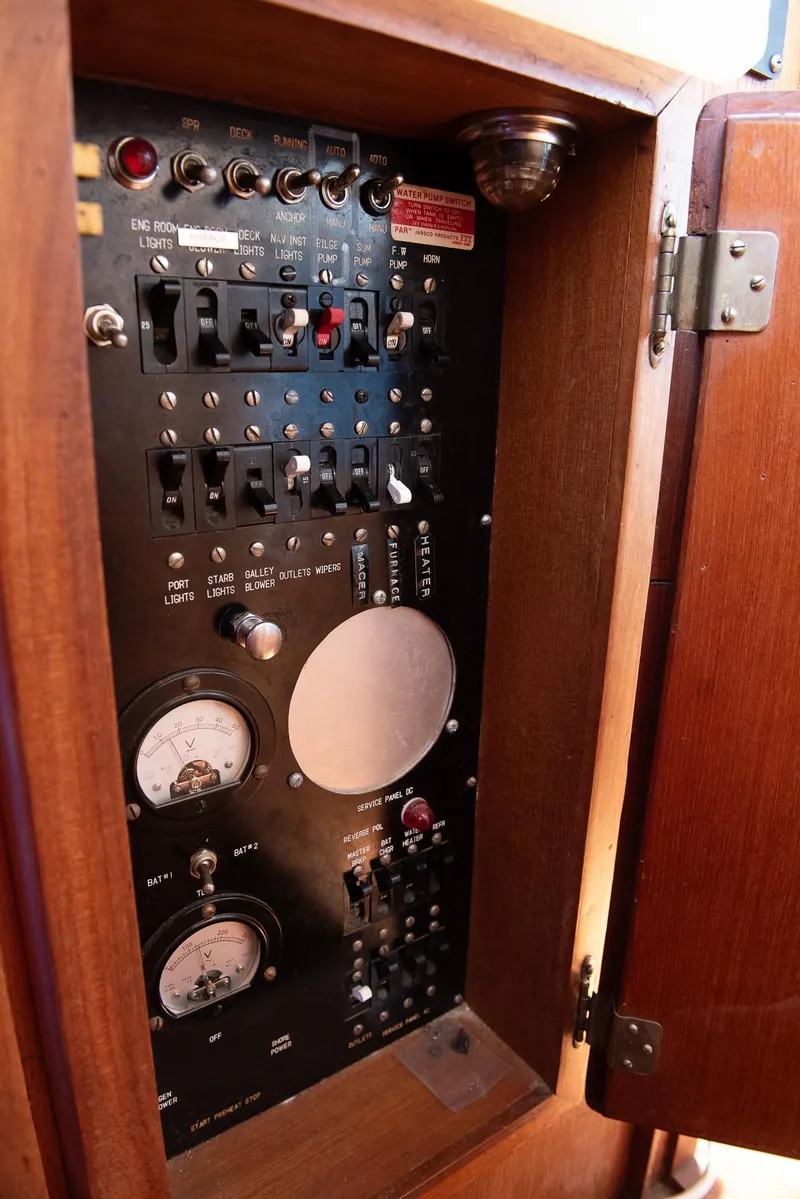 Slide: The Image of Electrical panel inside a 1978 CHB Puget Trawler 37 boat, featuring gauges and switches. - 20