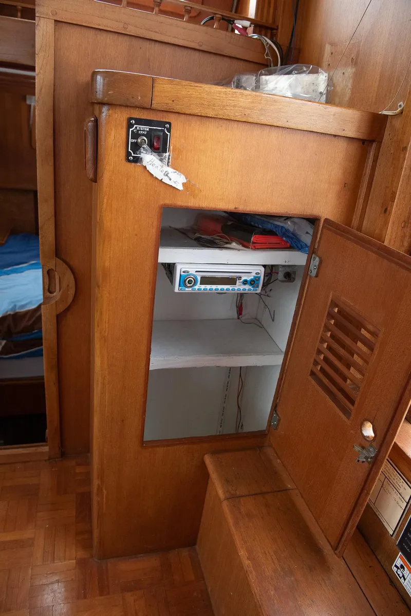 Slide: The Image of 1978 CHB Puget Trawler 37 interior with wooden cabinet and electronic equipment. - 25