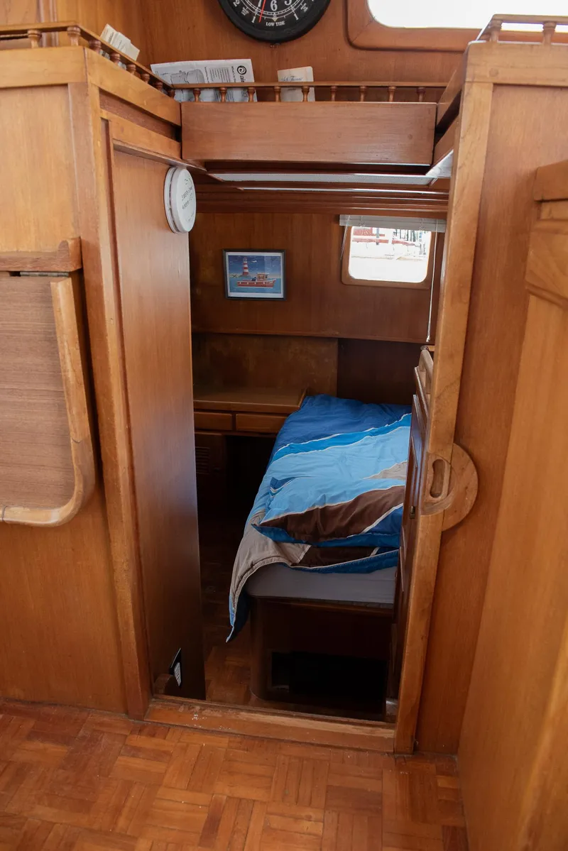 Slide: The Image of 1978 CHB Puget Trawler 37 interior cabin with wooden finish and cozy bed. - 28