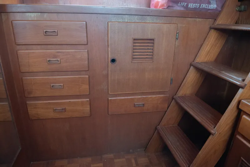 Slide: The Image of 1978 CHB Puget Trawler 37 interior with wooden cabinets and stairs. - 31