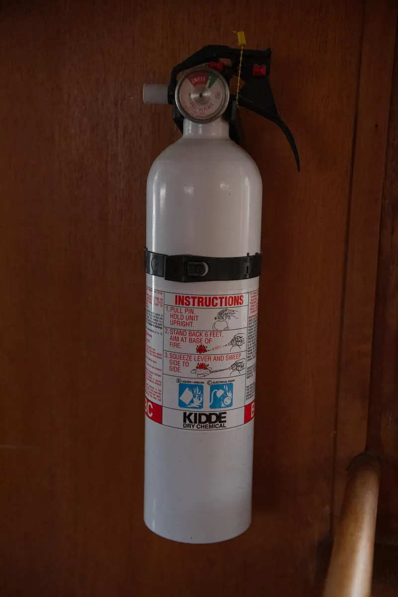 Slide: The Image of Fire extinguisher mounted on 1978 CHB Puget Trawler 37 wooden interior. - 36