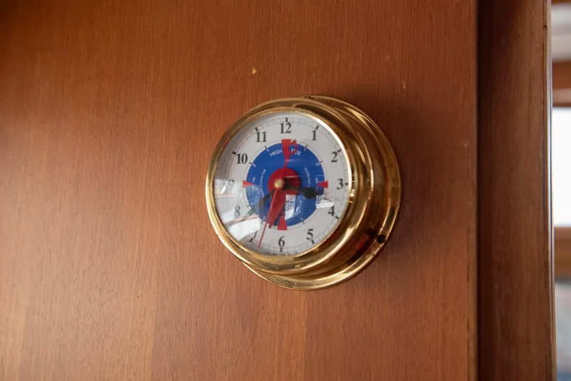 Slide: The Image of Brass nautical clock on CHB Puget Trawler 37, 1978 model, mounted on wooden panel. - 37