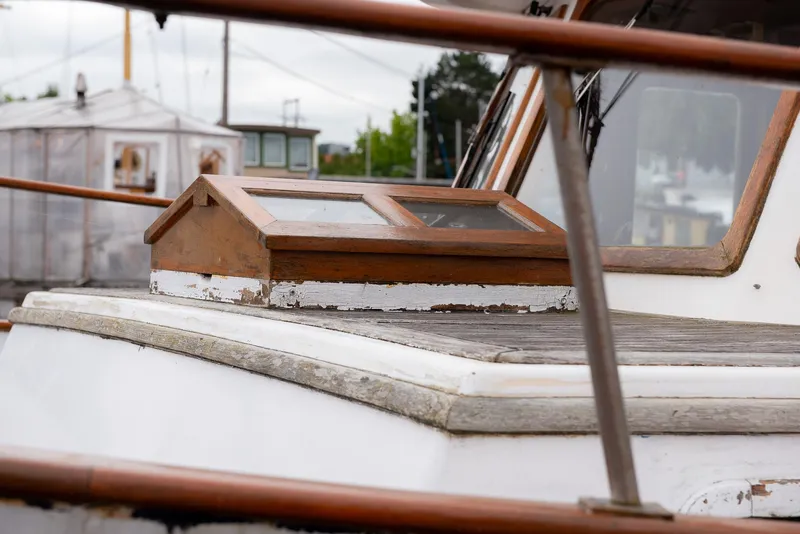 Slide: The Image of 1978 CHB Puget Trawler 37 boat deck with wooden details. - 42