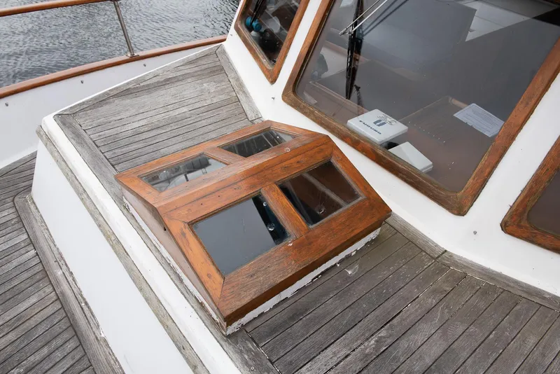 Slide: The Image of 1978 CHB Puget Trawler 37 wooden deck and cabin windows. - 43