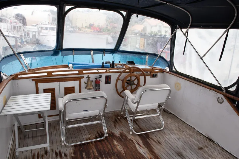 Slide: The Image of 1978 CHB Puget Trawler 37 helm with wooden steering wheel and seating. - 45