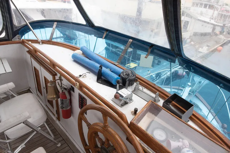Slide: The Image of 1978 CHB Puget Trawler 37 helm station with wooden wheel and navigation equipment. - 46