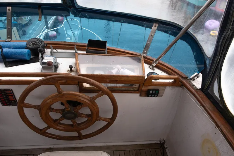 Slide: The Image of 1978 CHB Puget Trawler 37 helm with wooden steering wheel and navigation instruments. - 47