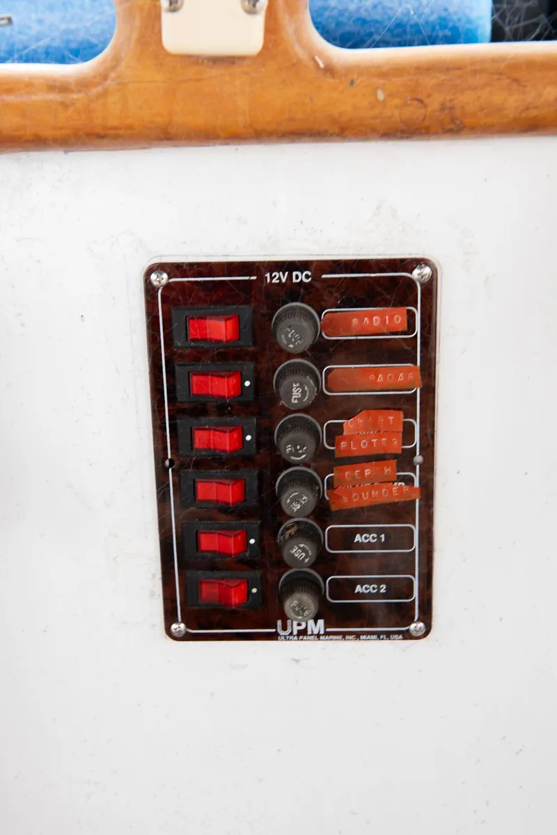 Slide: The Image of 1978 CHB Puget Trawler 37 electrical panel with 12V DC switches and indicators. - 51