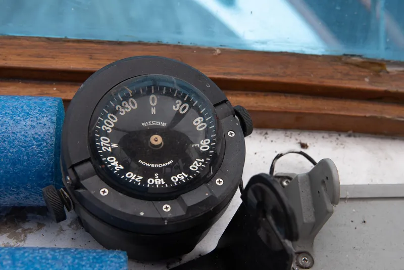 Slide: The Image of Close-up of a compass on a 1978 CHB Puget Trawler 37 boat. - 52