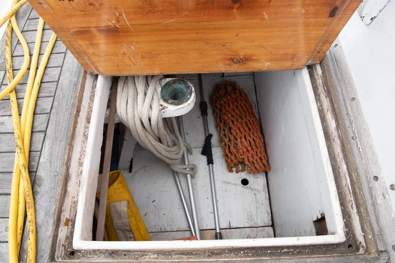 Slide: The Image of Storage compartment of a 1978 CHB Puget Trawler 37 with ropes and equipment. - 54