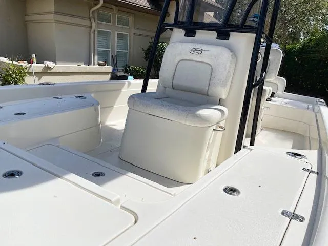 Slide: The Image of 2019 ShearWater 23LTZ boat interior with white seating and storage compartments. - 11