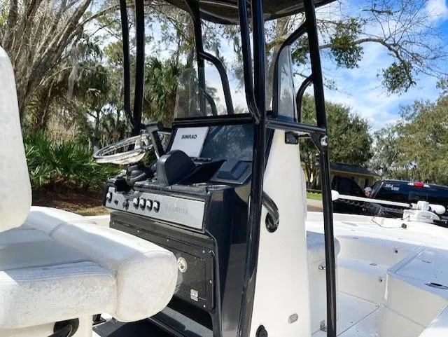 Slide: The Image of 2019 ShearWater 23LTZ boat console and seating area. - 13