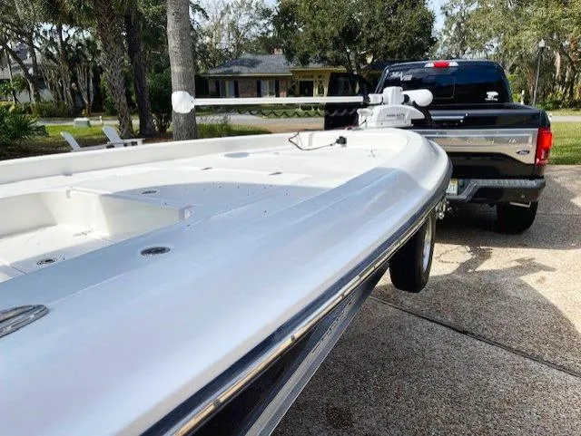 Slide: The Image of 2019 ShearWater 23LTZ boat hitched to a black truck in a driveway. - 14