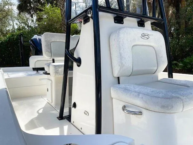 Slide: The Image of 2019 ShearWater 23LTZ boat interior with white cushioned seats and black frame. - 15