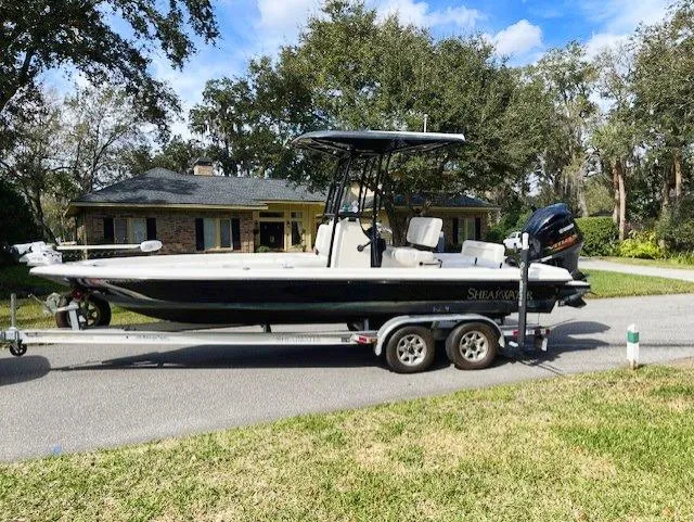 Slide: The Image of 2019 ShearWater 23LTZ boat on a trailer in a residential area. - 20