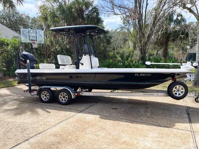 Slide: The Image of 2019 ShearWater 23LTZ boat on a trailer in a driveway. - 3