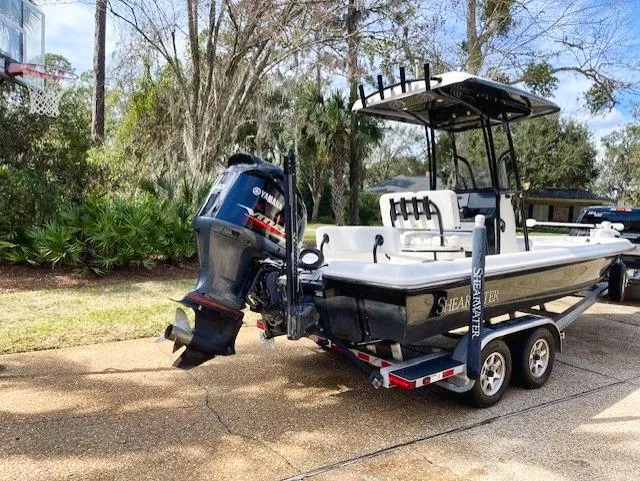 Slide: The Image of 2019 ShearWater 23LTZ boat on a trailer with Yamaha outboard motor. - 4
