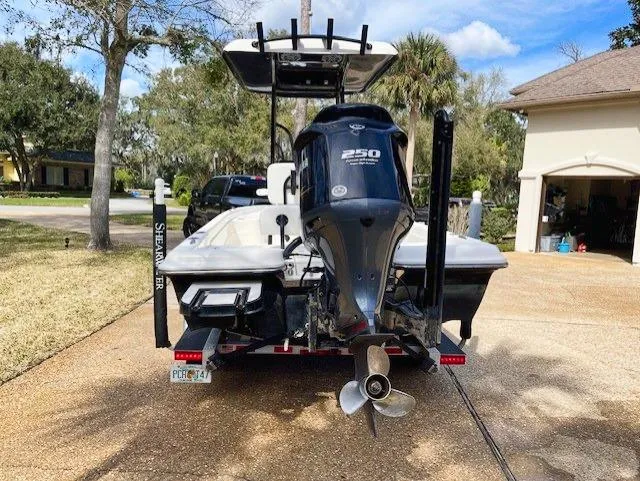 Slide: The Image of 2019 ShearWater 23LTZ boat with 250 HP engine, parked in driveway. - 5