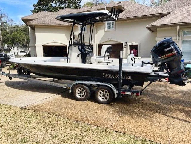 Slide: The Image of 2019 ShearWater 23LTZ boat on trailer in front of house. - 6