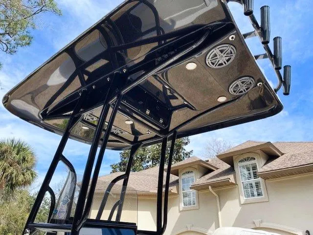 Slide: The Image of 2019 ShearWater 23LTZ boat with T-top and rod holders. - 8