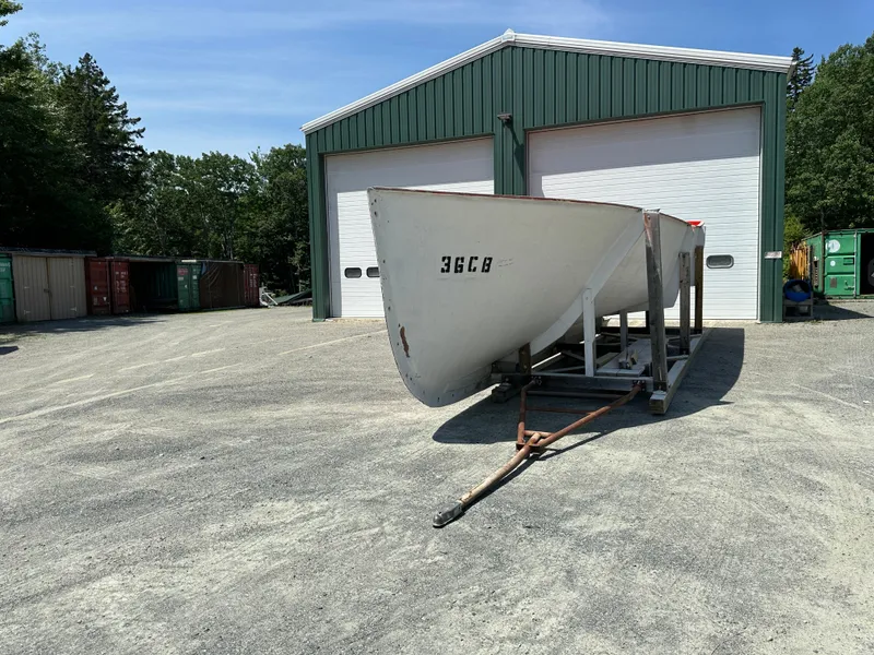 Slide: The Image of 2024 Beal Calvin Beal MOLDS boat hull on trailer outside a green warehouse. - 14
