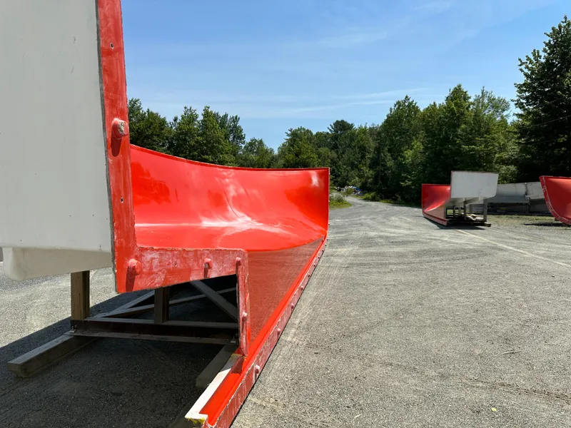 Slide: The Image of Red Calvin Beal MOLDS boat hulls, 2024 model, displayed outdoors on a sunny day. - 15