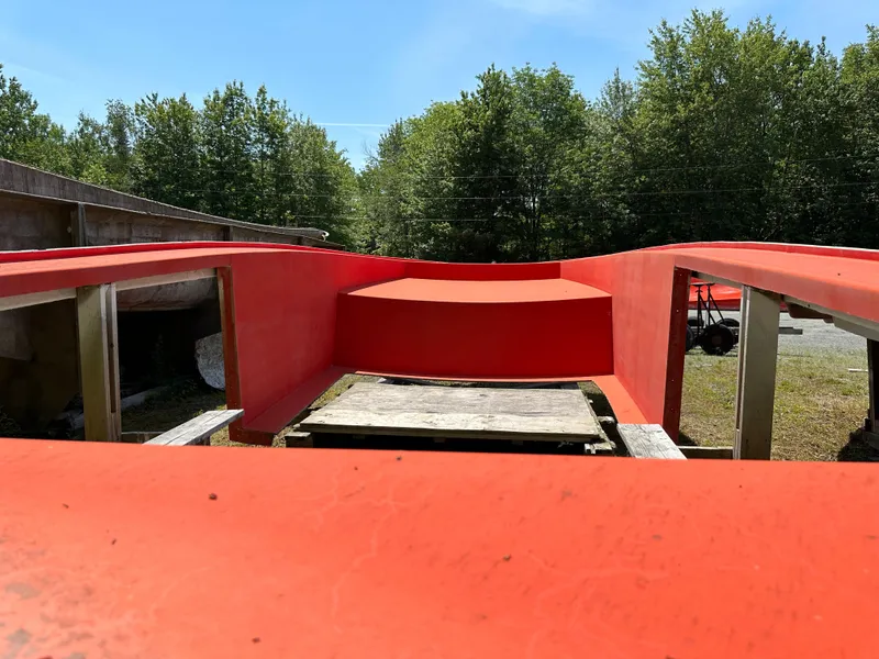 Slide: The Image of Red boat mold by Beal, Calvin Beal MOLDS 2024, outdoors with trees in background. - 16
