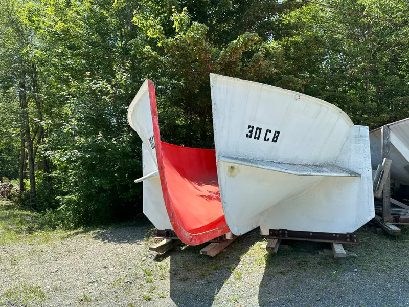 Slide: The Image of 2024 Beal Calvin Beal MOLDS boat hulls displayed outdoors, surrounded by trees. - 22