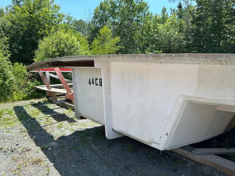 Slide: The Image of 2024 Beal Calvin Beal MOLDS boat hull outdoors, surrounded by trees and greenery. - 3