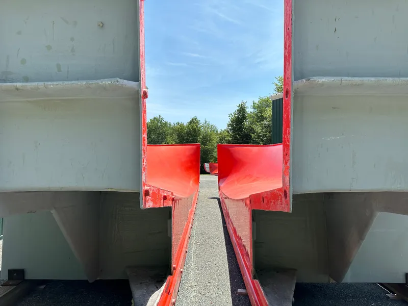 Slide: The Image of 2024 Beal Calvin Beal MOLDS with red and gray structure under blue sky. - 6