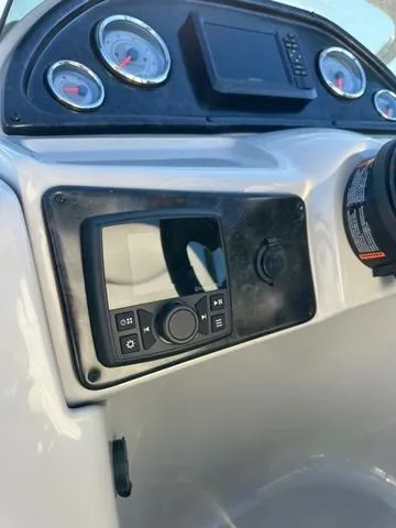 Slide: The Image of 2024 SunCatcher Fusion 322FC boat dashboard with gauges and control panel. - 11