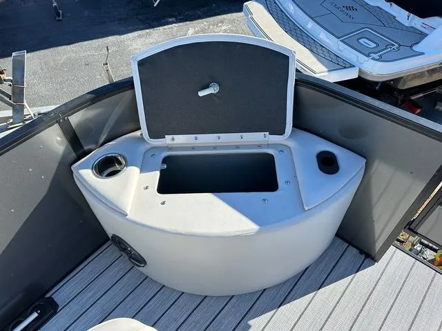 Slide: The Image of 2024 SunCatcher Fusion 322FC boat with open storage compartment and cup holders. - 18